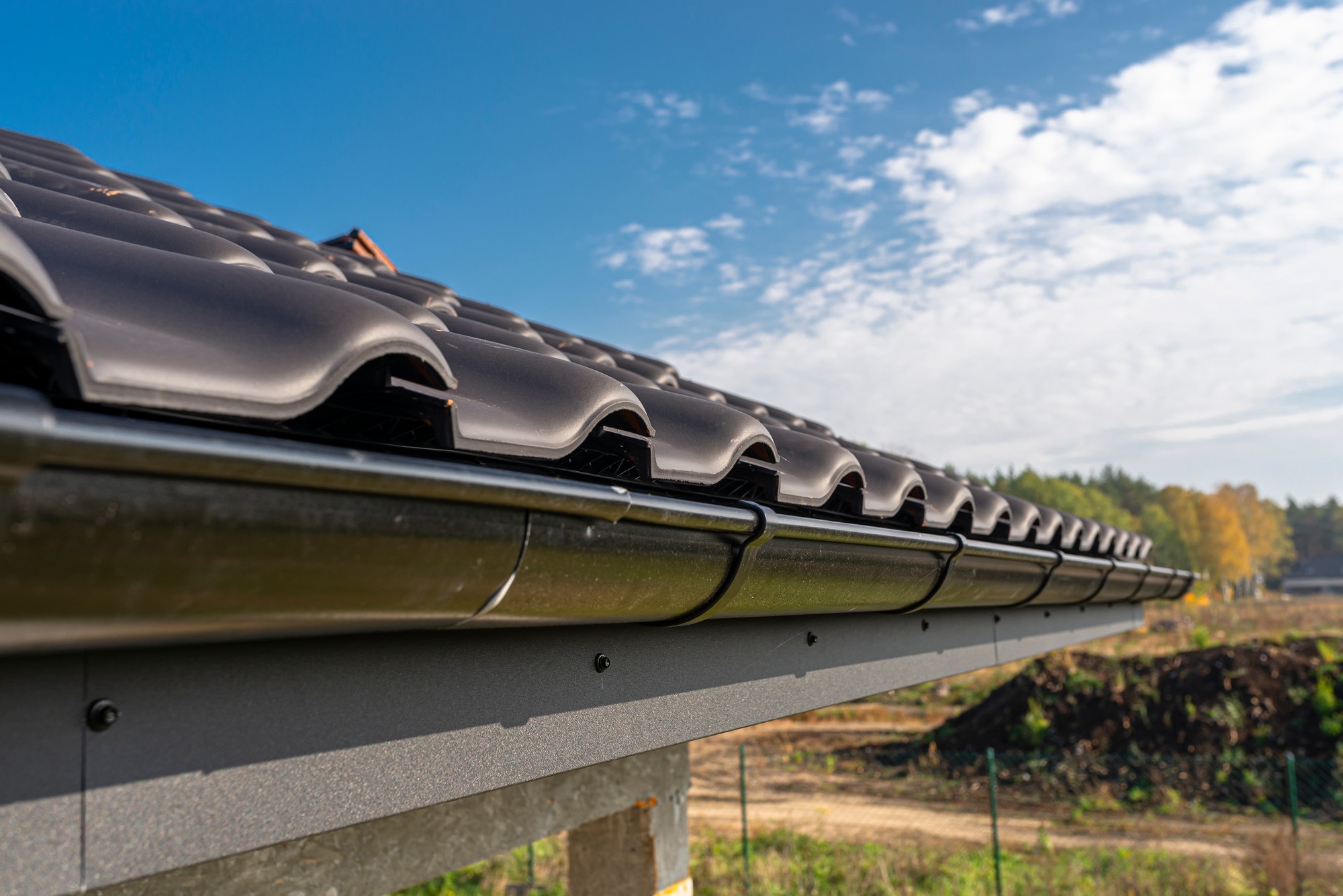 A Metal Black Gutter On A Roof Covered With Ceram 2022 11 10 18 01 31 Utc