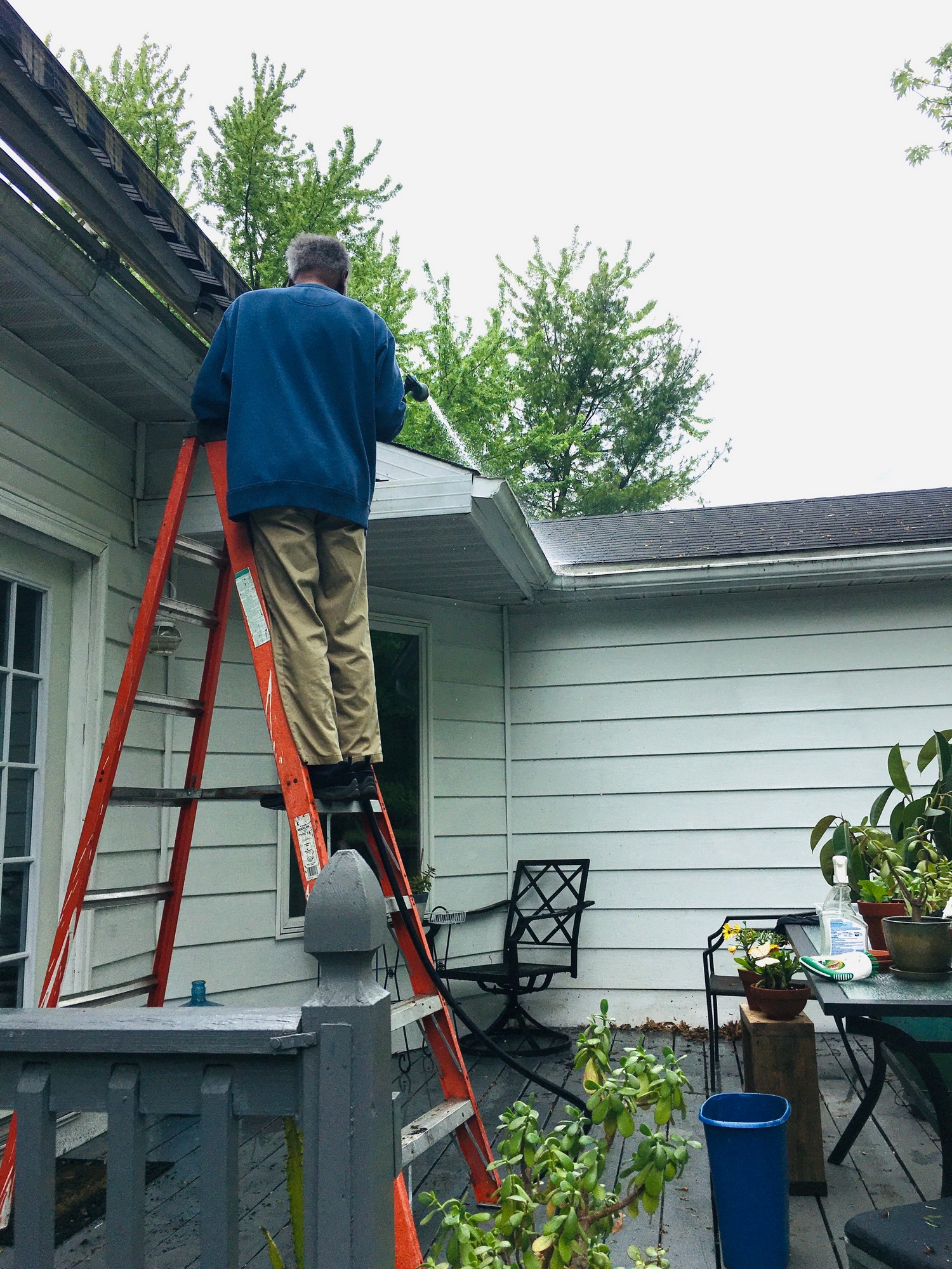 Man On Ladder Cleaning Gutters On Roof 2022 10 26 05 49 12 Utc