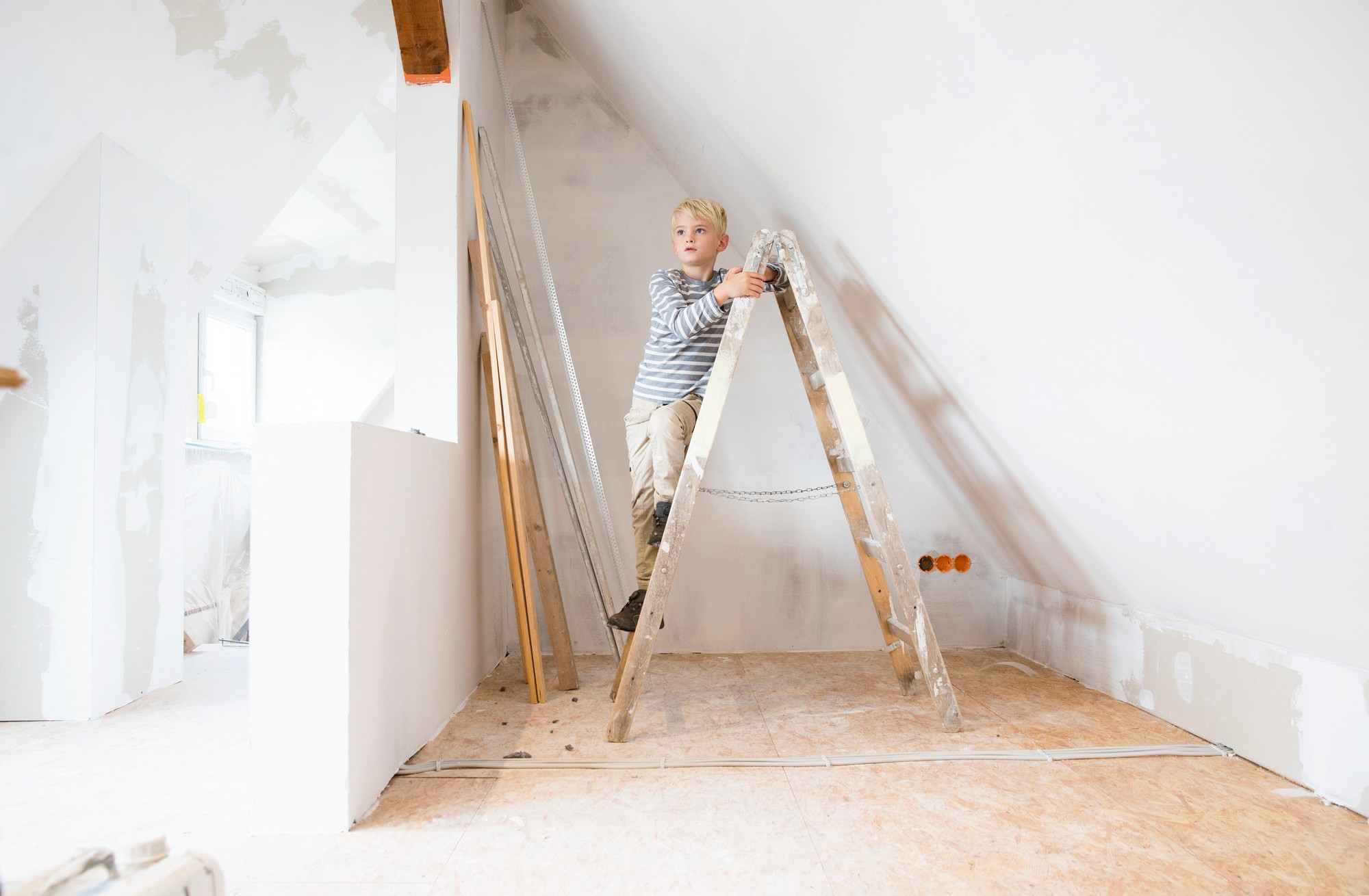 Boy Standing On Ladder In Attic To Be Renovated 2022 12 16 22 13 10 Utc